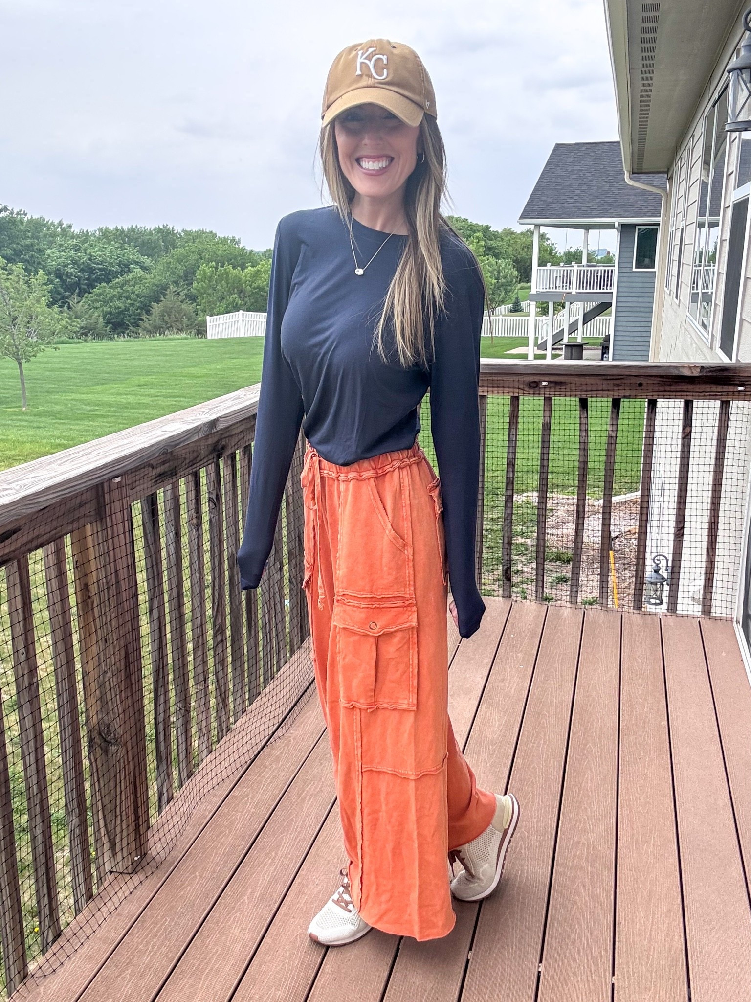 Loving this casual and comfy vibe on this rainy day! 🧡 Wearing a small in the orange pants and small in the navy top.

As an Amazon Influencer I earn commission on qualifying purchases.

Mom style, what to wear this spring, casual fashion, comfy styles, orange cargo sweatpants, navy blue long sleeved top, Kansas City Royals hat

#LTKootd #LTKOver40 #LTKMidsize