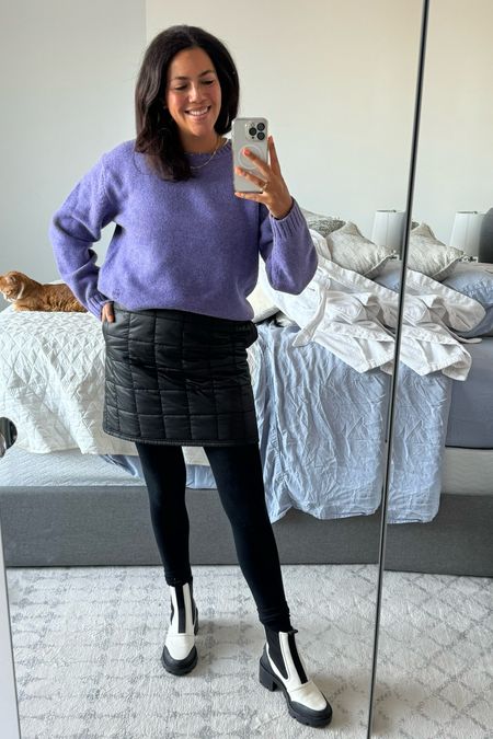 Winter work outfit with a pop of bright color! A chunky wool sweater in a bright purple (old Tory Burch, size small) tucked into a Tucky (size M/L) pops over a black quilted mini skirt (Tory Burch, size medium). Fleece lined tights from target (size M/L) keep me warm and I think black trouser socks look so cute scrunched down on top of these white lug sole Chelsea boots (Tory Burch, size 11). Gold jewelry finishes off the look! Stacked necklaces are Madewell and Ring Concierge, earrings are from an Amazon set. 

#LTKworkwear #LTKmidsize #LTKSeasonal