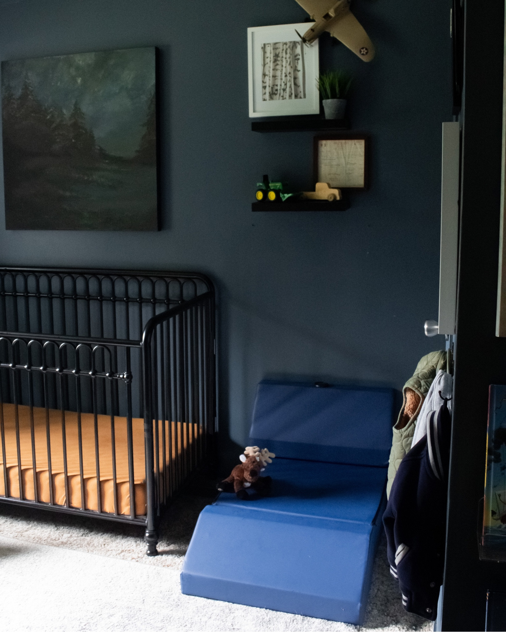 Navy blue baby boy nursery. Traditional baby boy nursery. Play couch for kids. Black metal crib. Toddler boy nursery. Toddler boy bedroom

Wall color is SW Rain Cloud. Art is a DIY, linked some with a similar vibe 

#LTKhome #LTKbaby #LTKfamily