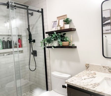 bathroom, shelf styling, small potted plants, picture frames, candle, small wire basket, towels, wood shelves, floating shelves

#LTKstyletip #LTKhome