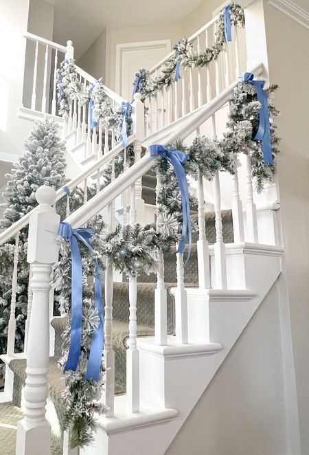Love this affordable flocked garland paired with French blue satin ribbon bows on my foyer stairs. Grandmillennial, coastal, blue & white, Christmas staircase  

#LTKHoliday #LTKSeasonal #LTKfindsunder50