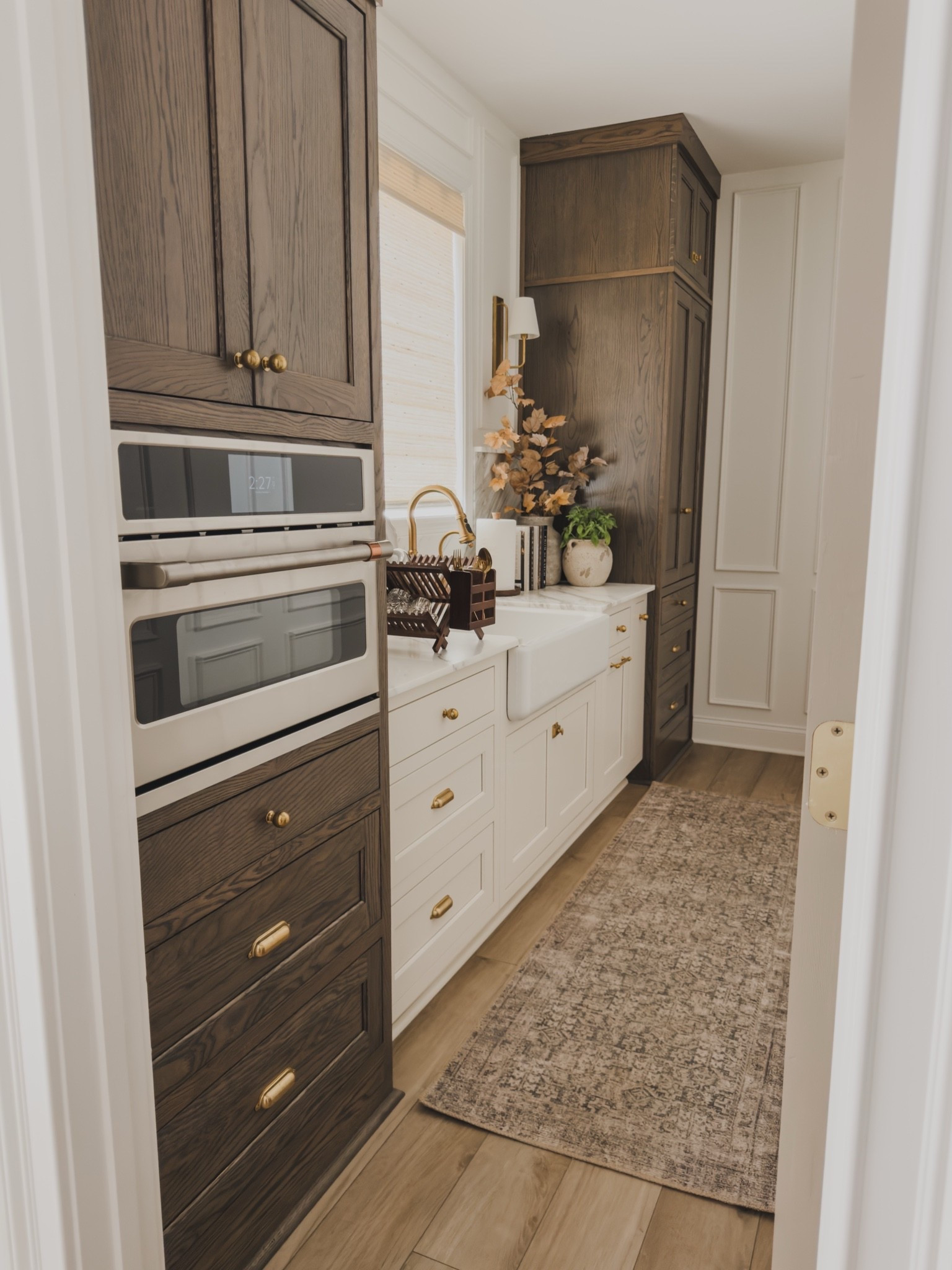 Cozy fall prep kitchen views in my home! Leaning into functional yet aesthetic living spaces while still creating a cozy, fall atmosphere.

Home finds, neutral home inspo, fall refresh, kitchen refresh, prep kitchen views, collected style, timeless home inspo, vintage style area rug, neutral wood tones, farmhouse sink, brass details, hardware details, appliance favorites, faux fall stems, wooden dish rack, neutral decor book, wall sconce, Rejuvenation, Pottery Barn style, Cafe, Wayfair, Two Pages, found it on Amazon, shop the look!

#LTKSeasonal #LTKHome