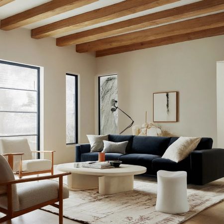 Neutral modern transitional living room design. Dark navy blue sofa, Upholstered wood arm accent chair. 

#LTKstyletip #LTKhome #LTKsalealert
