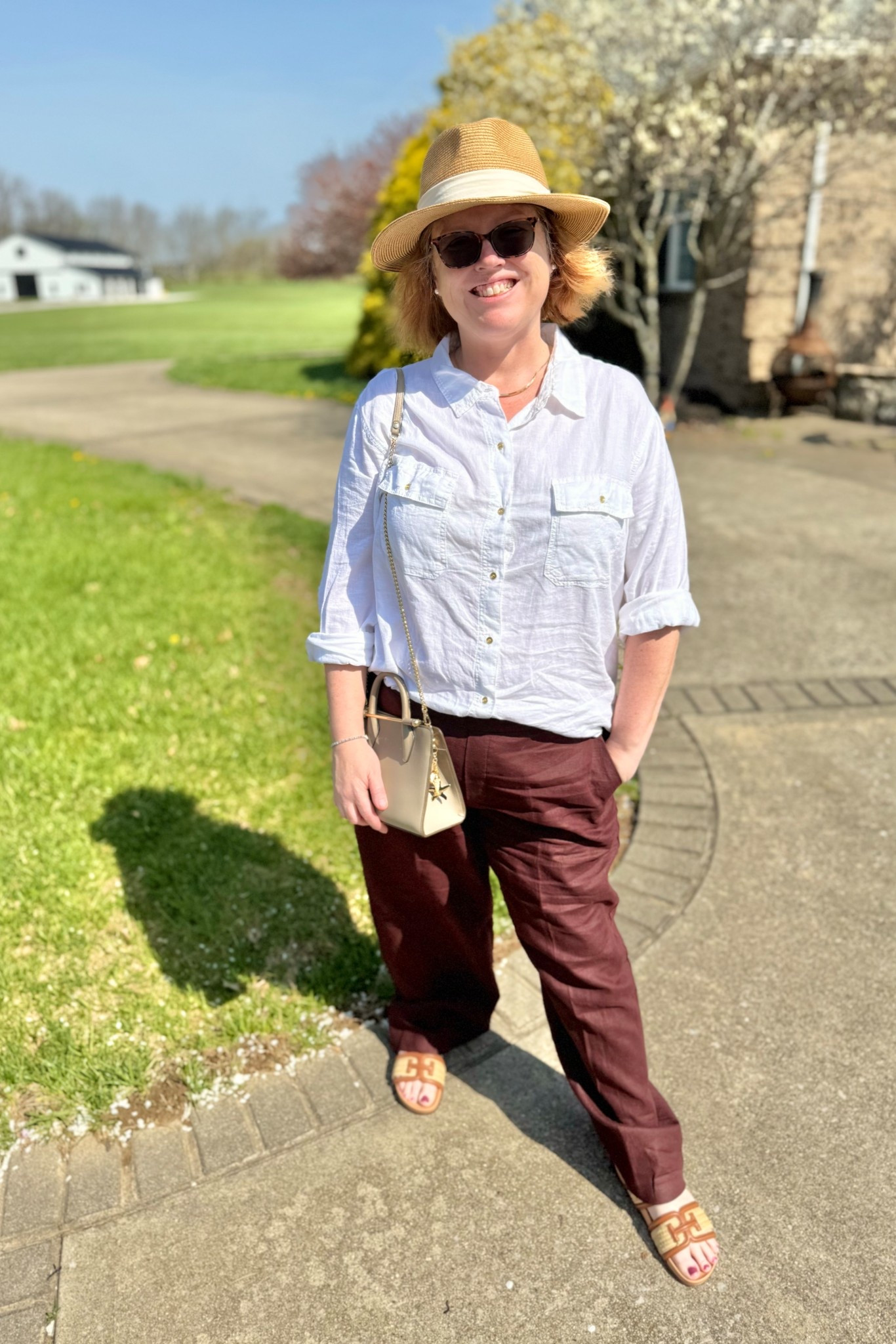 This summer outfit… I’m loving. I’ve paired my favorite shirt in white with these raisin linen pants. They are both flowy and comfortable. I’m wearing an XL in the pants and I’m usually a 16/18. This is a great outfit for running errands, a trip to the farmer’s market or out to brunch! #summeroutfit #sandals #linen #luxurybag #samedelman #summer-hat #vacationoutfit#LTKxMadewell #linenpants

#LTKShoeCrush #LTKOver40