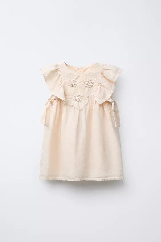 100% linen dress with a straight neck and short sleeves with ruffle appliqué. Back button closur... | Zara US