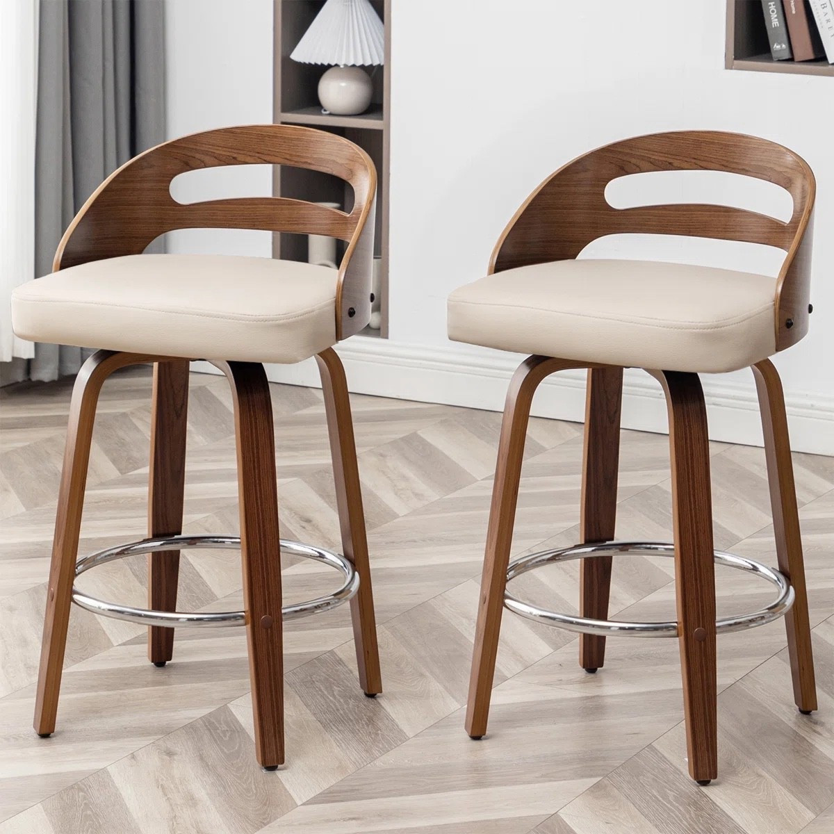These swivel bar stools from Wayfair are such a beautiful mix of mid century modern and contemporary style. The curved wood back, cream faux leather seat, and swivel design make them both stylish and comfortable for everyday kitchen seating. Love the warm wood tones paired with the neutral upholstery for creating a cozy and elevated kitchen or dining space. Perfect for kitchen islands, breakfast bars, and modern farmhouse homes.