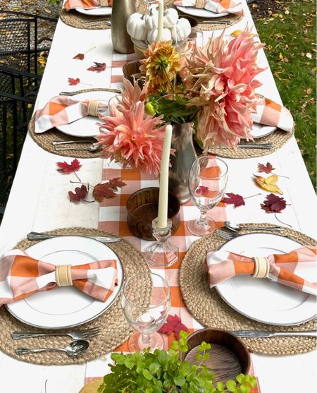 A pretty Fall table setting with buffalo print napkins and runner for an outdoor gathering. 
Fall tablescape/ faux mini pumpkins/ sea grass placemat/ wineglasses/ white plates

#LTKstyletip #LTKhome #LTKHoliday