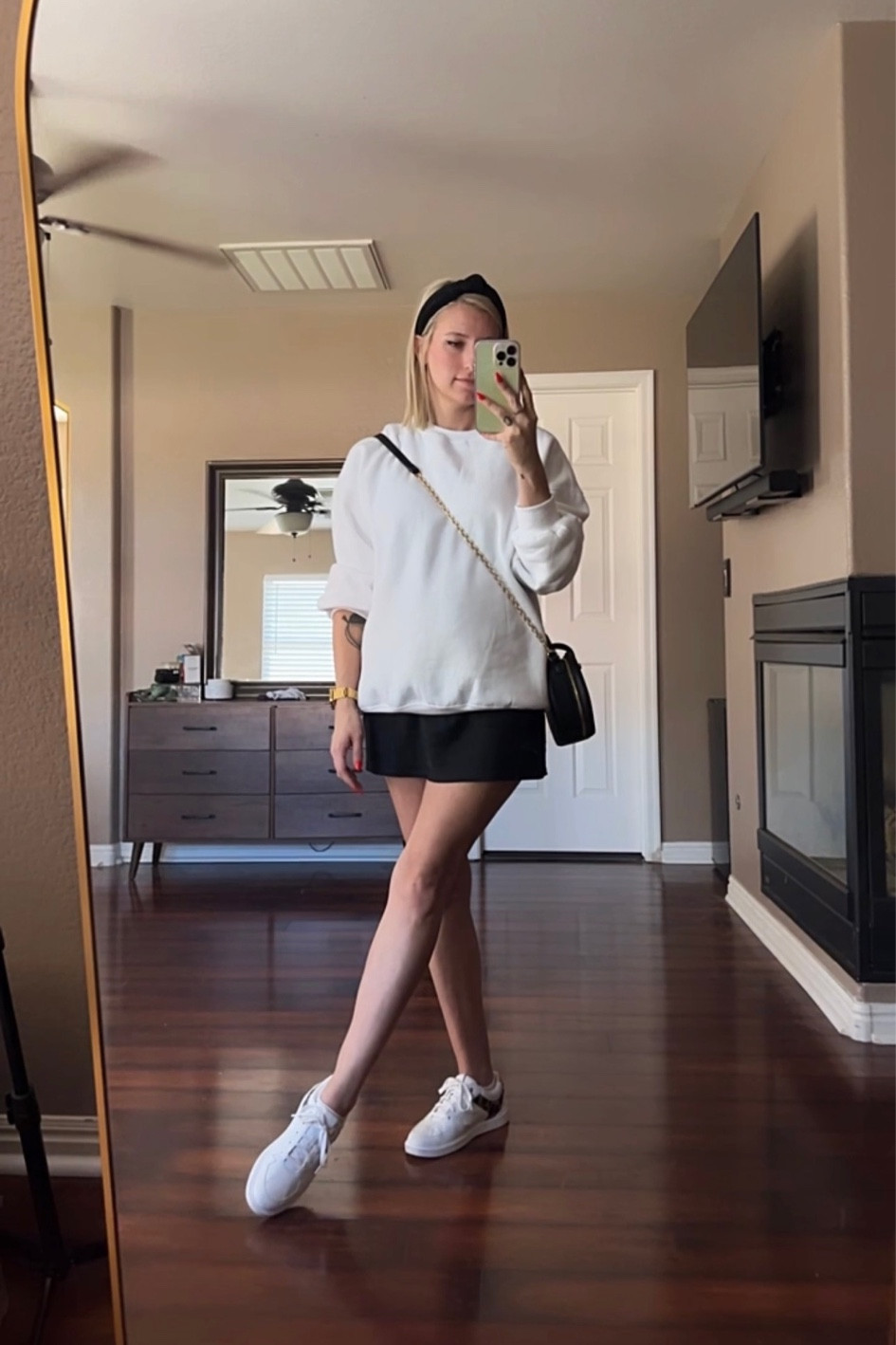 ootd easing into fall in las vegas with an oversized sweater layered on top of an abercrombie slip dress and paired with leopard print Vole Haan sneakers