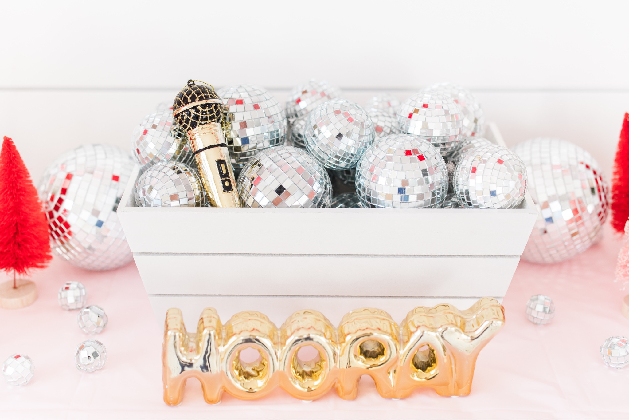 Disco ball table centerpiece.. an assortment of sizes (mostly all are ornaments that I put the top piece upside down to hide it) microphone is an ornament from Hobby Lobby and the white basket is from Target dollar spot. Gold hooray sign is years old from the Target dollar spot 

#LTKparties #LTKHoliday #LTKkids