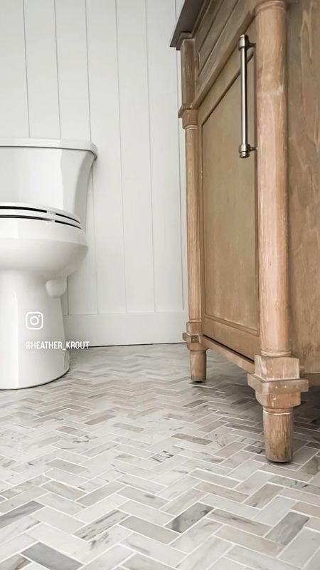 Bathroom vanity, bathroom tile floor, toilet, powder room floor, powder room vanity, bathroom floor, herringbone tile, coastal powder room decor, bathroom decor, bathroom vanity light fixture, brass wall light fixture.
Antique oak bath vanity with white Carrara marble top. Herringbone floor tile, wall tile with varied neutral tones.
#bathroomvanity #bathroomdecor #floortile #herringbone #powderroom 
Get the full details on this powder room remodel on heatherkrout.com

#LTKhome #LTKFind #LTKstyletip