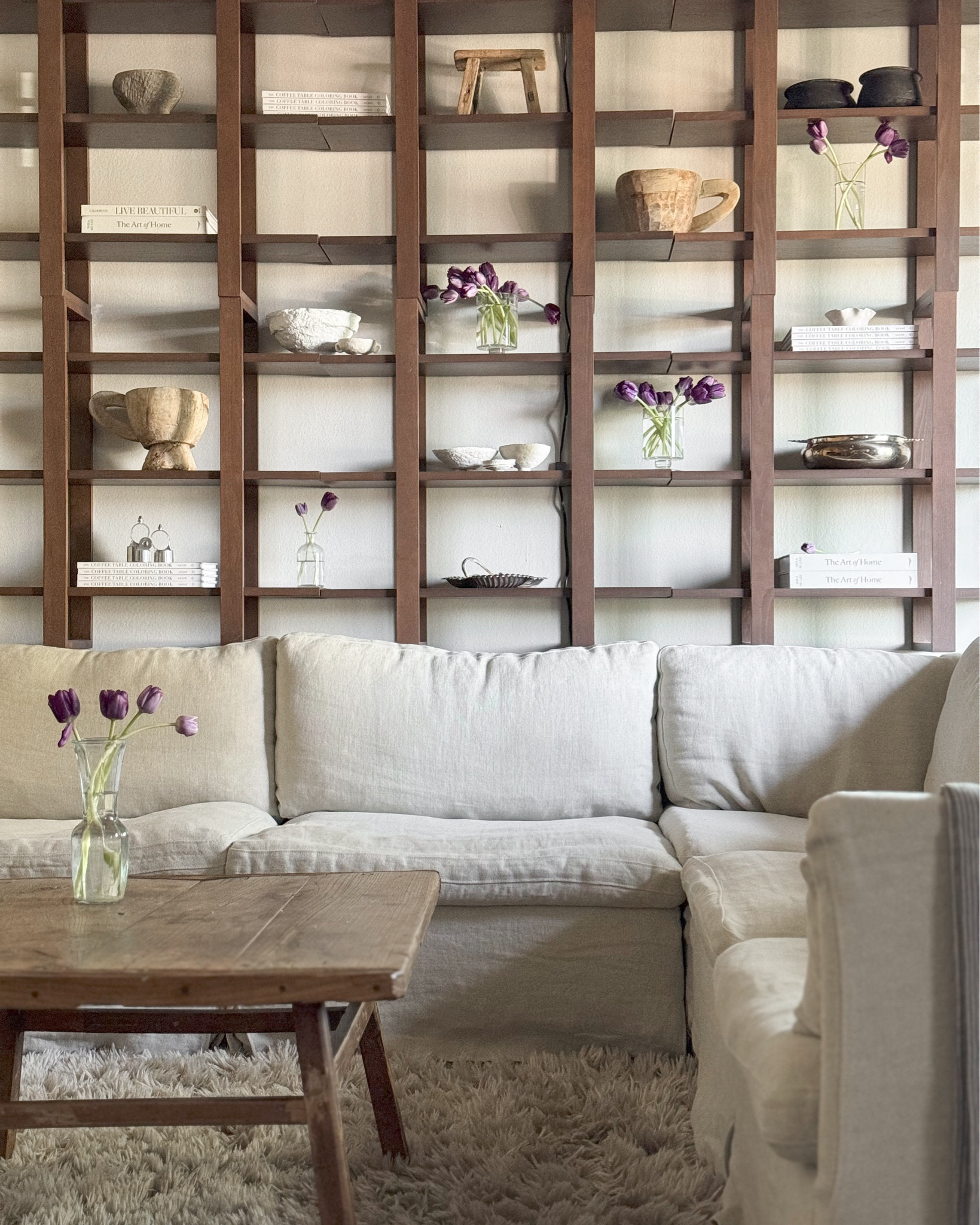 Here's how I'm designing my small space living room! Some small spaces can be very wonky in layout and just plain-old awkward, so here are a few tips that I hope will help you out when you're designing your small space:

MAKE THE ROOM FEEL LARGER: Paint ceiling and walls same color to elongate the walls.

ACHIEVING COZY: add in more textures and fabrics like: linen pendants or lanterns, textured curtains, shaggy rugs, knitted throw ballets, etc. 

DON'T FORGET ABOUT SCALE: Make sure your room has the right-sized furniture and accessories. The space needs to feel cohesive, and selecting items that are the proper size will make a world of a difference.  

CREATE MORE STYLISH STORAGE: Adding in things like shelves, dressers, carts, and baskets, help to organize and display your goods and collectibles.

STYLE YOUR HEART OUT: You don't always have to hide all of your pieces, styling them the right way makes for a beautiful display, and can be the perfect conversation-starter for when you have guests over. 

TIPS FOR SHELF STYLING: 
A) Create a color story B) Bring in different textures C) Play with height D) Create balance #smallspaces #smallspaceliving #smallspacesquad #storagehacks #storageideas #storagesolutions #storage #diy #diyhomeimprovement #diyhomeprojects 

#LTKhome