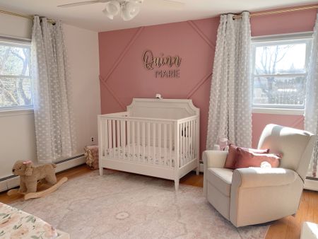 Pink flowers & dog themed nursery for baby girl. Geometric wood accent wall. Similar to wainscoting  

Crib, mattress, crib sheets, recliner / swivel glider, curtains, rug, wooden name display

#LTKhome #LTKfamily #LTKbaby