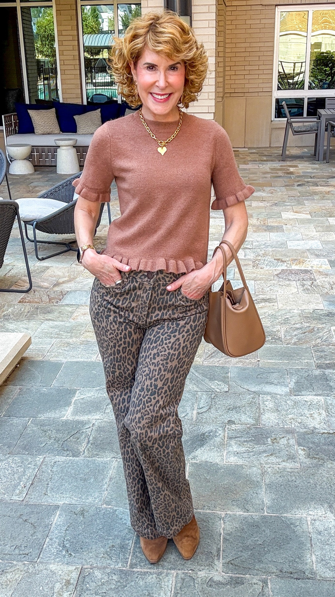Fall outfit idea featuring 40% off leopard print wide-leg jeans with a flattering high-rise contoured fit, paired with an up to 50% off brown ruffle short-sleeve sweater available in 4 colors. I finished the look with brown suede ankle boots, a structured cognac handbag, and gold heart jewelry for an easy elevated casual fall outfit for women.

#LTKootd #LTKOver40 #LTKSeasonal