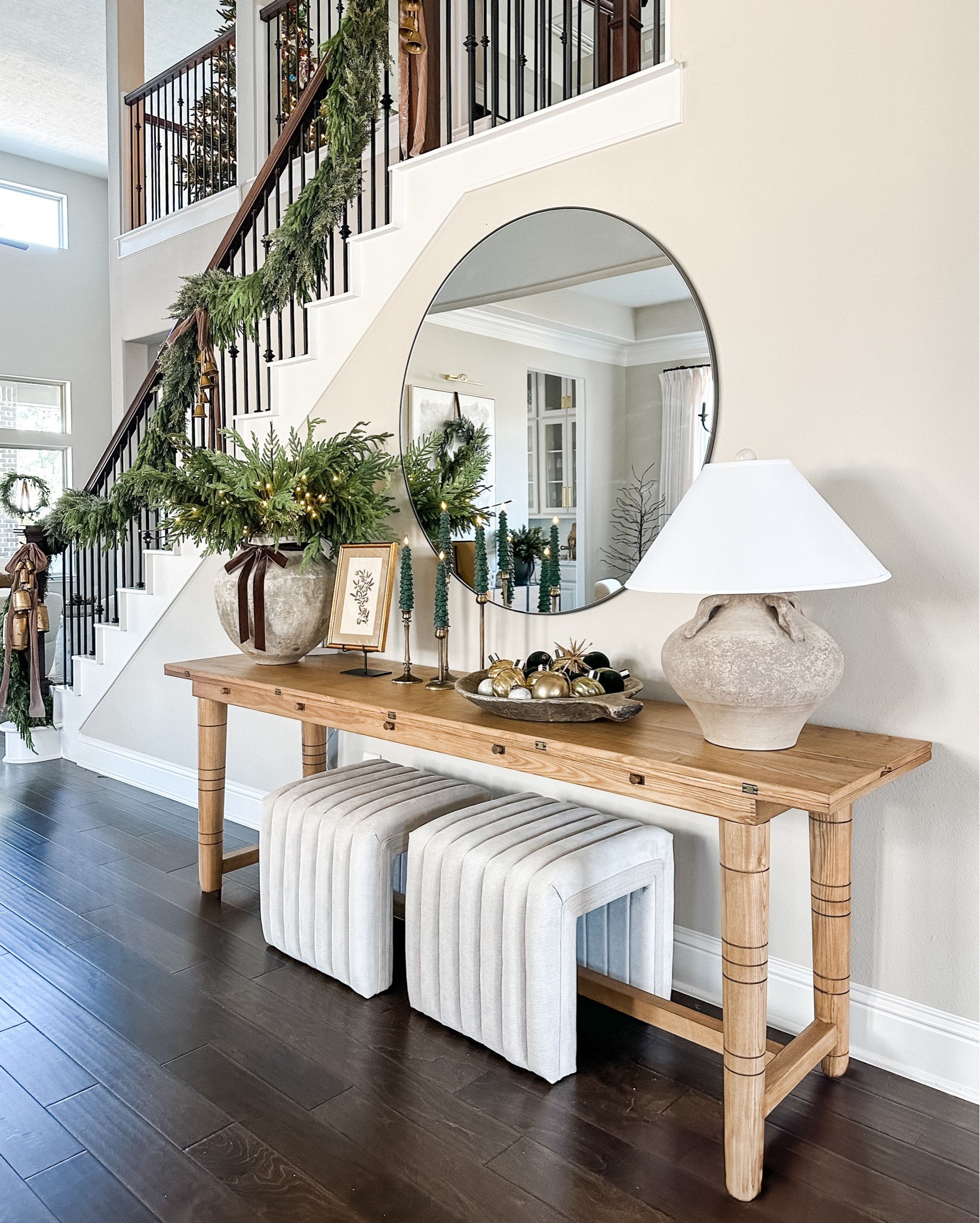 Entryway decorated for the holidays. I kept it simple on the table. I did an oversized vintage vase (I purchased it a a vintage shop) with light up branches, Norfolk pine stems, a large bowl filled with ornaments, I did my favorite taper candle holders in the shape
Of Christmas trees. And of course the stairs wouldn’t be complete without garland and ribbon 

#LTKHome #LTKHoliday #LTKStyleTip