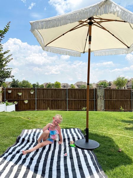 Washable outdoor blankets are a summer essential around here, and the ones by Little Unicorn (available on Amazon) are my favorite because they’re XL and roll-up for easy carry. 

The fringe outdoor umbrella is available at Walmart, but currently out of stock. Sign up for restock alerts to get a notification when it becomes avail. 

#LTKhome #LTKkids #LTKSeasonal
