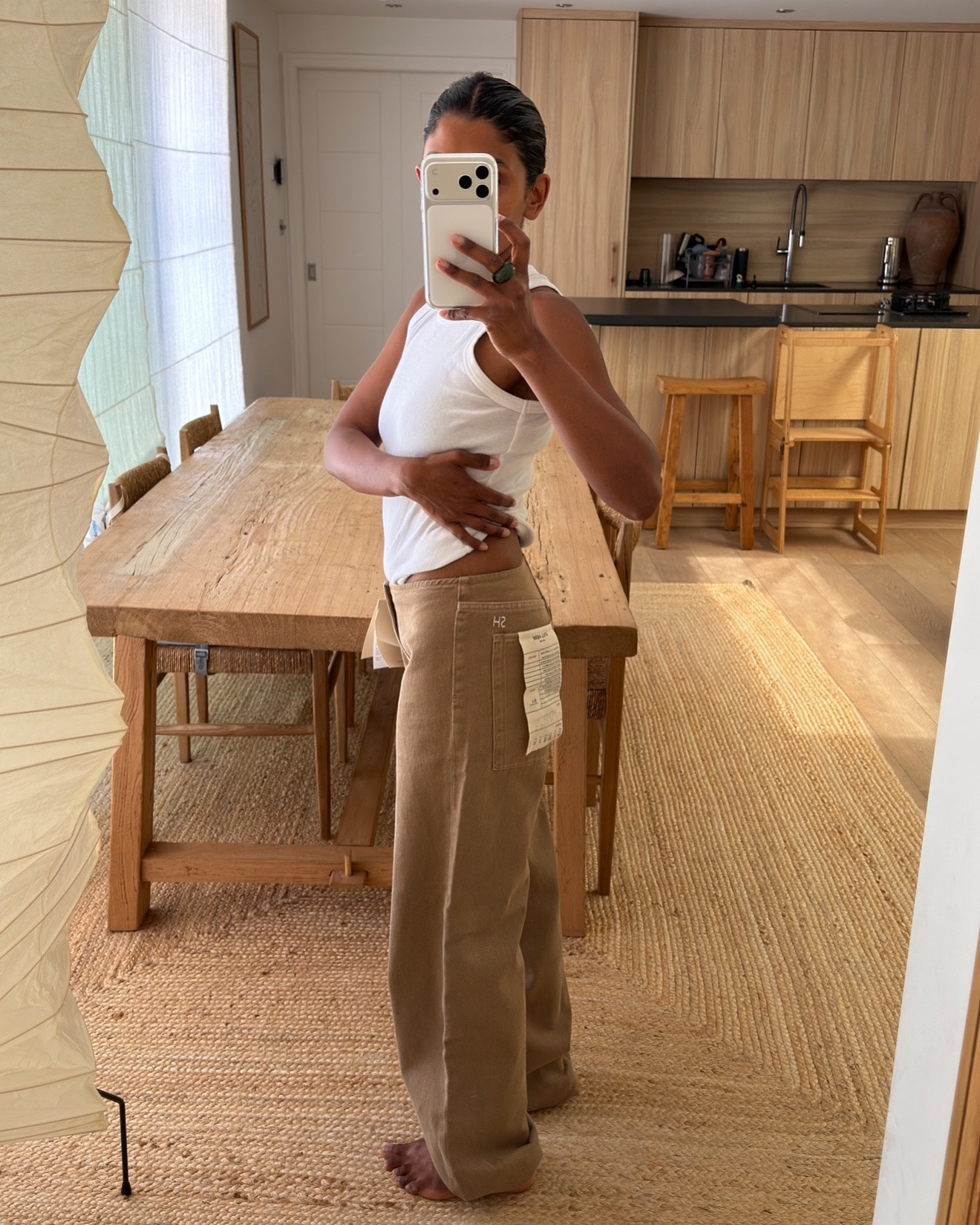 Finally got my hands on the @stillherenewyork Sport Jean in Pear - here are my notes 

• I’m probably a UK 6 at the moment. Usually a waist 23/24 in jeans. I wear a 23 in The Row Eglitta and all my Citizens of Humanity jeans
• Ordered both the 23 and 24 because I knew they’d sell out
• Girls online say to size down as they stretch - some kept their usual size and had them altered later
• Others said it depends on the look: TTS or one size up if you want them more relaxed with a little room
• Size down if you want them really fitted on the waist and bum
• Both sizes fit well, but the 23 felt a little tight around the crotch area - and I know I’d have to feel slightly uncomfortable for them to work, so I’m keeping the 24
• Love them when the elastic ankle tie is pulled tight. I’m 5’1 so the extra fabric feels a little heavy around the ankle
• Think I’m going to have them shortened slightly 📞 Diana @scobies_valetservice
• Will report back in a few weeks on stretch etc.

Hope that helps if you were debating sizing 🍐