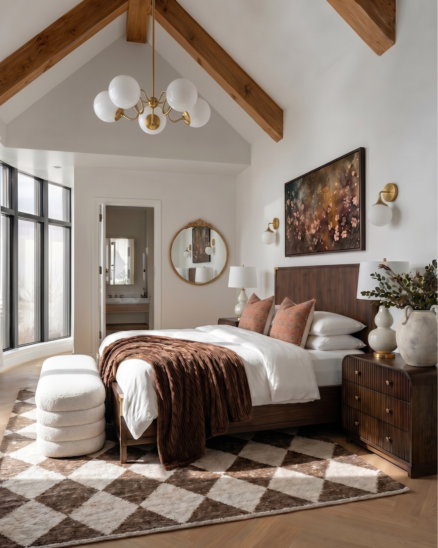 Warm modern bedroom design featuring a rich wood bed frame with brass accents, styled with crisp white bedding, textured neutral throw blanket, and terracotta accent pillows for a cozy, elevated look. A plush upholstered bench adds softness at the foot of the bed, layered over a geometric brown and cream area rug.
Matching wood nightstands with fluted detailing are styled with ceramic table lamps, decorative vases, and stacked books for a balanced, designer feel. Above the bed, a statement abstract art piece ties together warm earthy tones, complemented by modern brass wall sconces.
The space continues with a coordinating fluted wood dresser styled with neutral ceramic decor, a framed botanical print, a glass hurricane candle holder, and a decorative tray with small accessories. A cozy accent chair with soft upholstery and wood frame pairs perfectly with a matching round side table, topped with a candle for a warm, inviting touch.
 modern bedroom furniture, warm neutral bedroom decor, wood bed frame, upholstered bench, fluted dresser, designer nightstand styling, ceramic table lamps, abstract wall art, brass wall sconces, cozy accent chair, neutral home decor, earthy tone bedroom, luxury bedroom styling, high-end furniture look for less, transitional modern decor.

#LTKsale #LTKhome