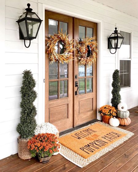 Front porch and door decor fall autumn harvest seasonal entry French double doors oversized layered scatter rug and doormat pumpkin magnolia trees faux artificial silk florals mums baskets wreaths outdoor lanterns wall sconces rocking chairs light fixtures southern modern farmhouse style home decor nearly natural amazon finds Etsy wayfair marshalls TJ Maxx home goods Walmart autumn oak trees 

#LTKhome #LTKSeasonal #LTKHalloween