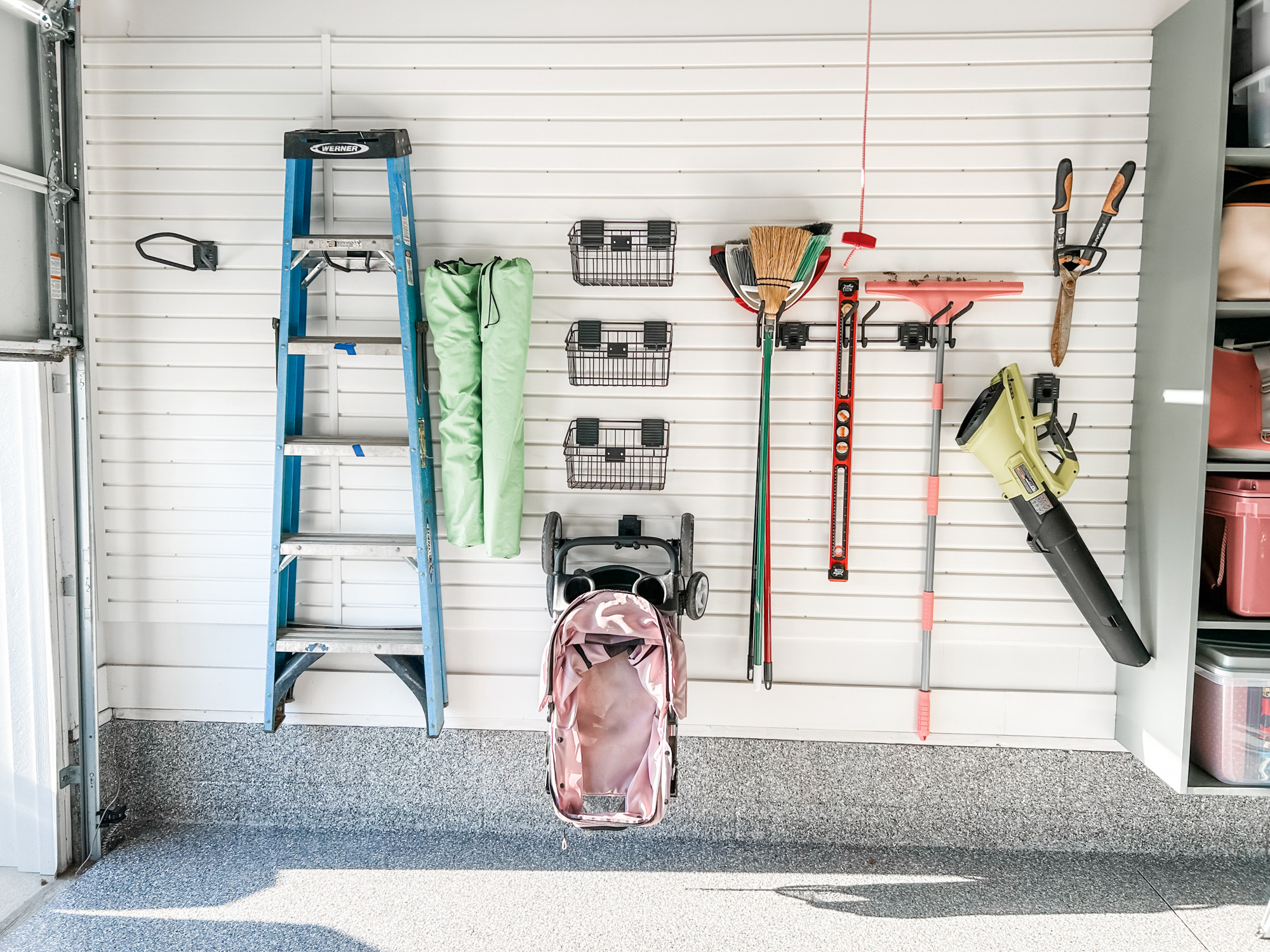 We love a good slat wall in the garage! They are super functional and maximize so much space on the wall. They help get all the things up off the floor and keep them accessible. 

 