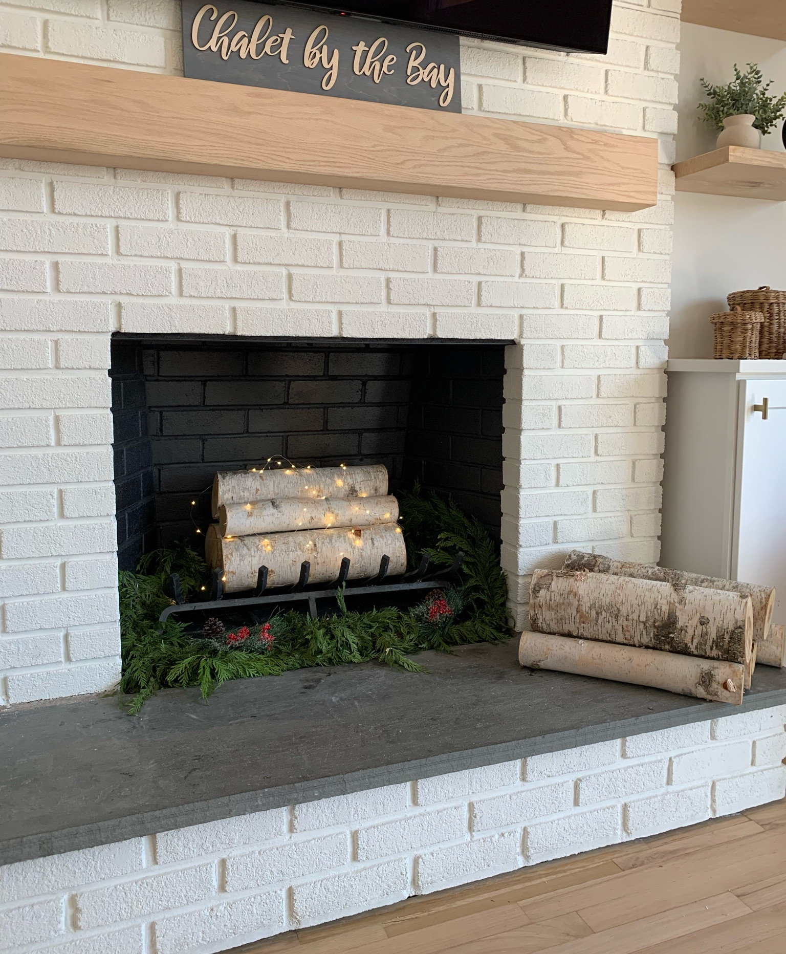 Real birch wood logs for when we’re not using the fireplace.  Added some greenery and white fairy string lights for Christmas decor. Painted the inside with fireproof black paint for a crisp look  

Birch trees
Mantle
Hearth
Home
Living room decor
Decorations
Faux
Knobs
Pulls
Cabinets
Battery operated lights
Holiday decor
Wreath
Garland

#LTKunder100 

#LTKhome 

#LTKFindsUnder50 #LTKHome #LTKHoliday