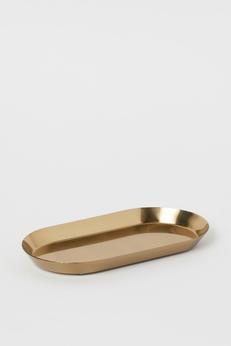 Small oval tray in metal with feet at base. Size 5 x 9 3/4 in., height of rim approx. 3/4 in. | H&M (US + CA)