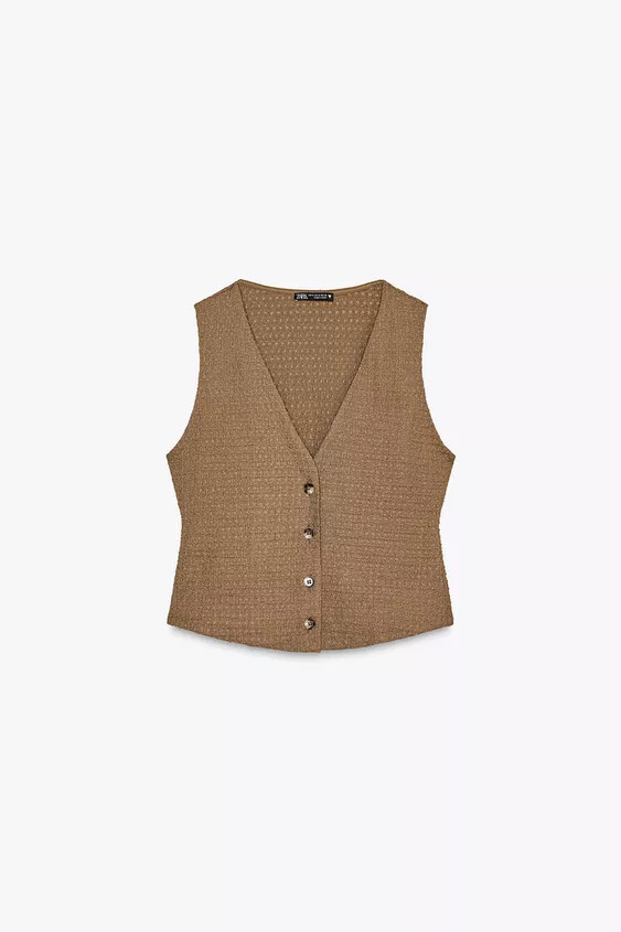 Textured woven top with a V-neck, sleeveless design and front button fastening. | Zara US