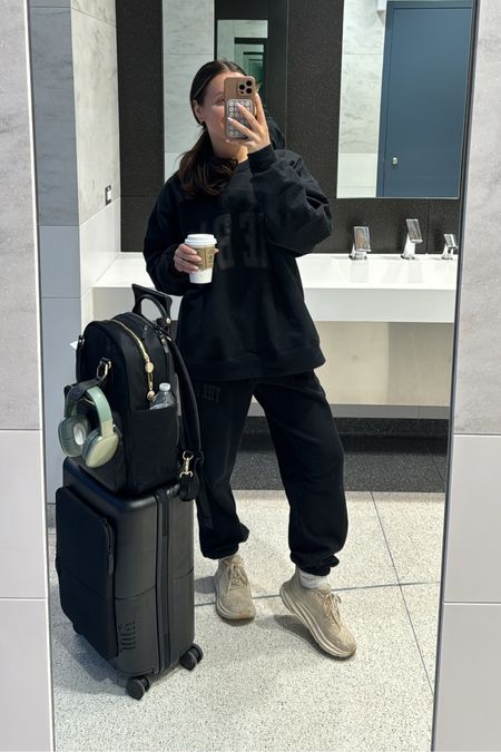Comfy airport travel outfit- wearing an XL in the sweatshirt and small in the sweatpants. Carry on luggage, backpack with laptop case, $25 Amazon wireless earphones that look like the apple AirPod maxes. 

#LTKfindsunder50 #LTKtravel