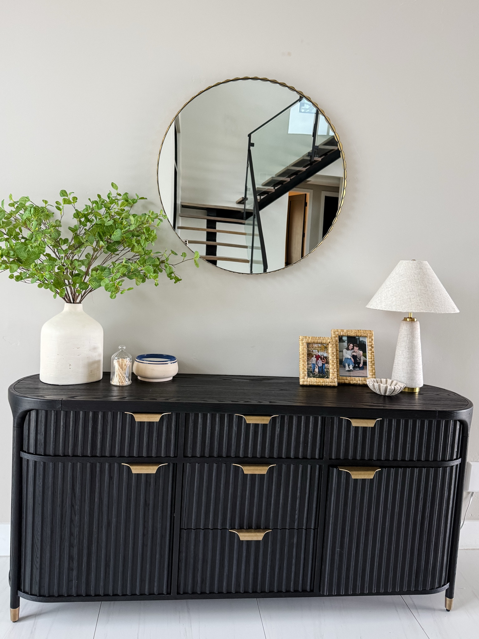 Summer entry console table with raffia frames and blue candle