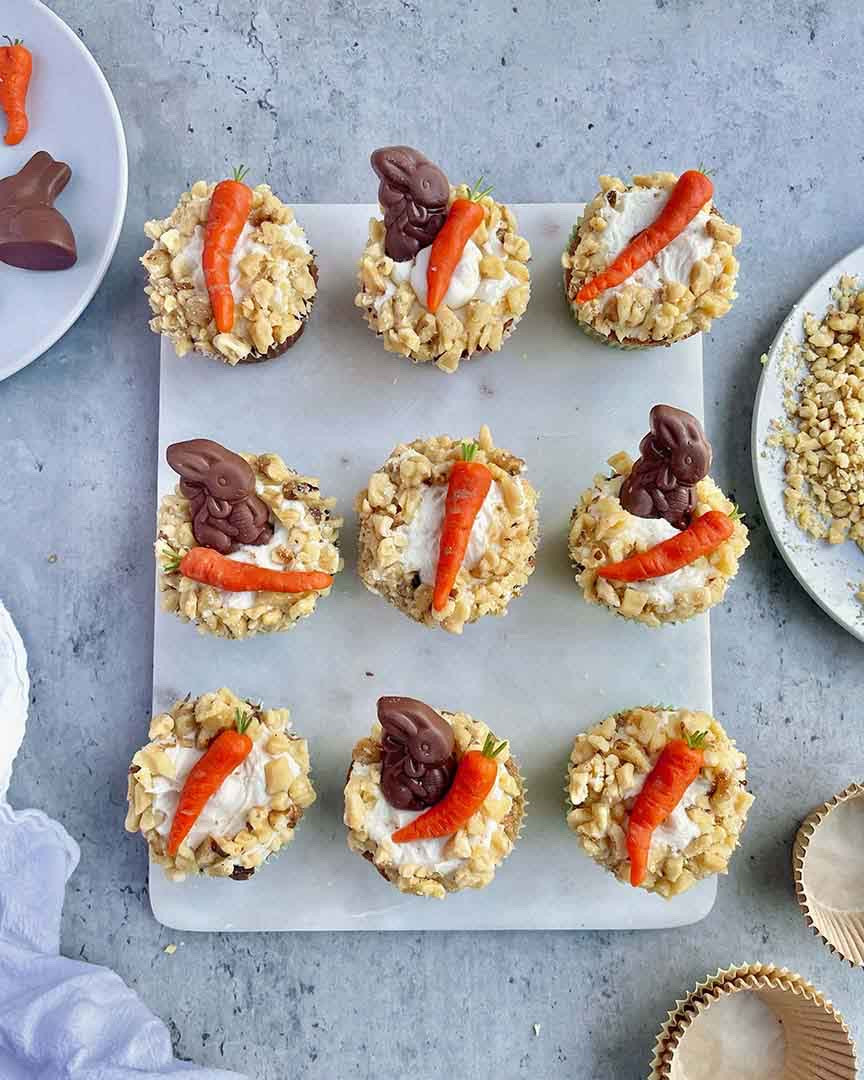 Instructions 
* In a small bowl, combine the marzipan and food coloring until evenly incorporated. Add more food coloring, as needed, to reach the desired color. Make sure to add the coloring in small amounts, it’s easy to over do it! (pro tip: wear gloves when mixing in the color and molding the carrots unless you want orange hands.) 
* On a flat, clean surface, roll the marzipan out into a long, slim log and divide into even 2-inch segments. Shape each segment into carrot-like cone shapes.  
* Dip a toothpick in the cocoa powder, then use the coated toothpick to create grooves and lines to give the marzipan carrots a realistic, fresh-from-the-garden look. 
* To top it off, cut a parsley stem to resemble a carrot greens. I prefer parsley because it doesn’t have a super strong flavor, but you can use any stemmy green herb you have on hand! 
* Nestle the carrot on top of the icing alongside the chocolate bunny. Sprinkle the icing with walnuts or press them into the outside edge of the icing to create a delicious, nutty ring.y

#LTKHome #LTKSeasonal #LTKfoodie