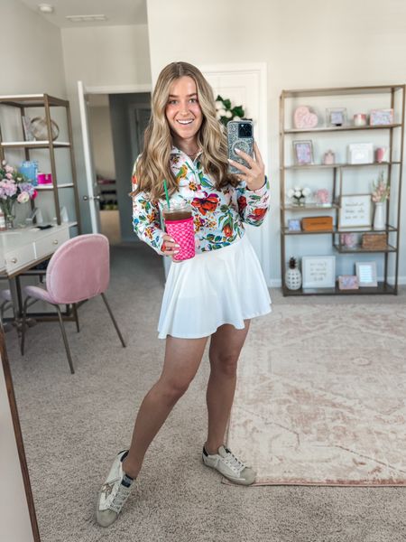 Tennis skirt. Vera Bradley pullover. Iced coffee koozie. Spring outfit. Travel outfit  

#LTKtravel #LTKfindsunder50 #LTKSeasonal