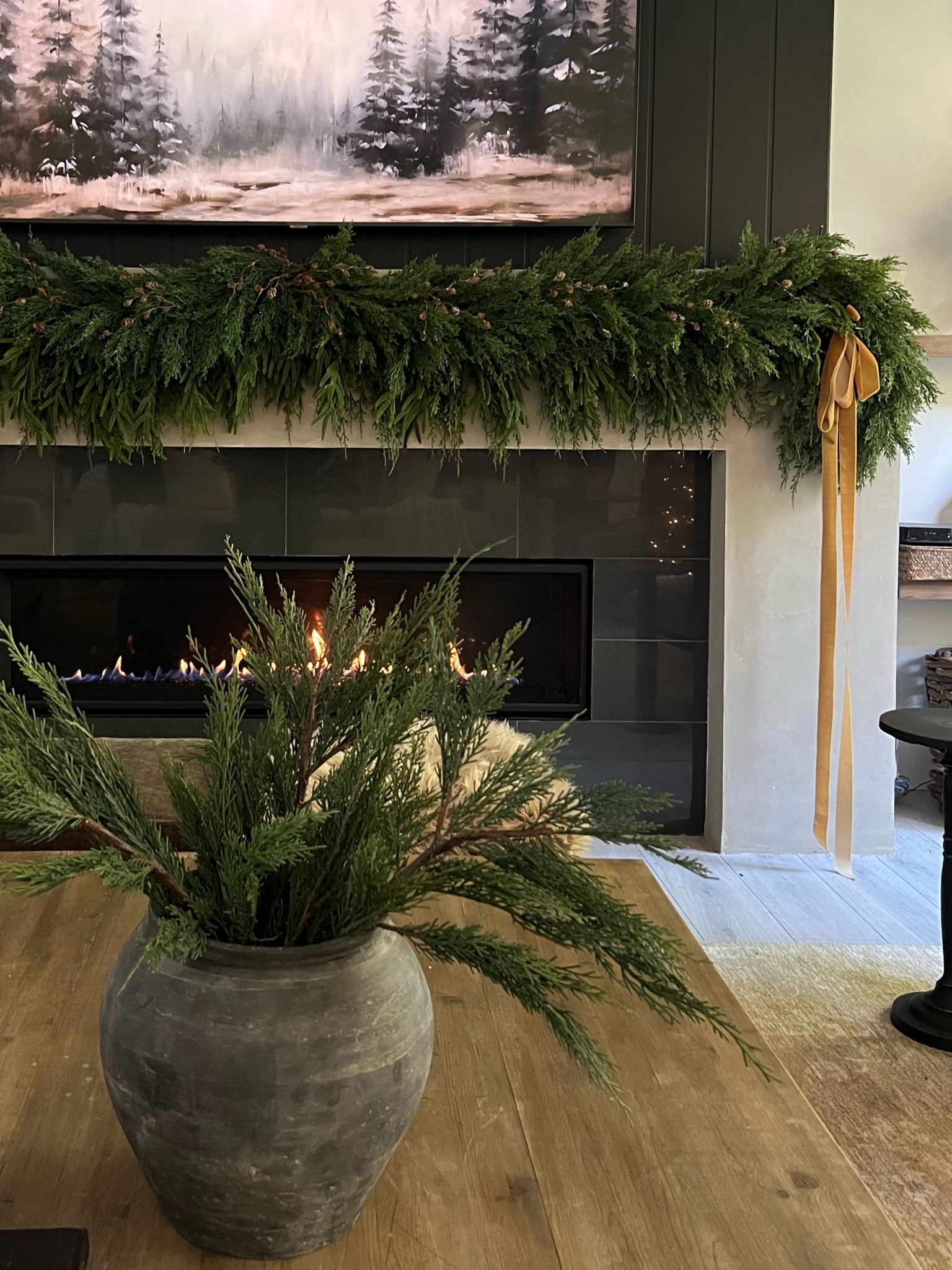 Holiday mantel: layered garland for fullness. 
I used three different types of garland to create this look. 
Bottom layer is the hanging cedar and pine garland from Michael’s, and then a draping Norfolk pine and the full cypress garland on top. 
Mini pinecone stems and velvet ribbon bows!  
Holiday decor, natural Christmas 

#LTKHome #LTKSeasonal #LTKHoliday