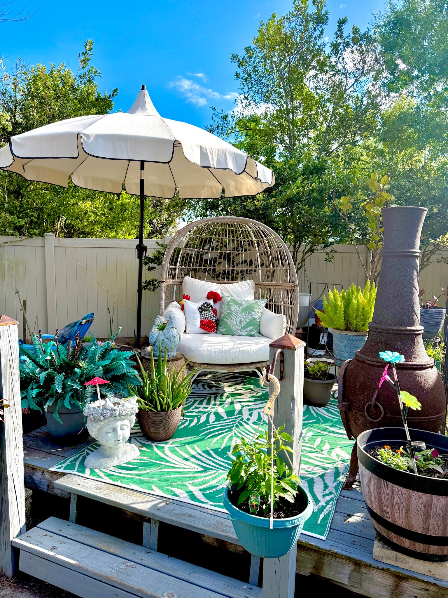 It’s not Better Homes & Garden picture perfect but it’s my lil piece of Heaven that I enjoy! 

My Texas House 9ft Outdoor Round Market Patio Umbrella with Off-White Canopy and Black Trim

Better Homes & Gardens 18" x 18" Green Palm Outdoor Pillow

Mainstays Green Palm Plastic Outdoor Rug, 5'x7'

Steel Southport Rust Resistant Outdoor Patio Egg Chair Black - Threshold

Reedley Large Kentucky Walnut Brown Resin Wine Barrel Lightweight Round Planter (20 in. L x 20 in. W x 14.5 in. H)

Chimnea

#LTKOver40 #LTKHome #LTKSeasonal