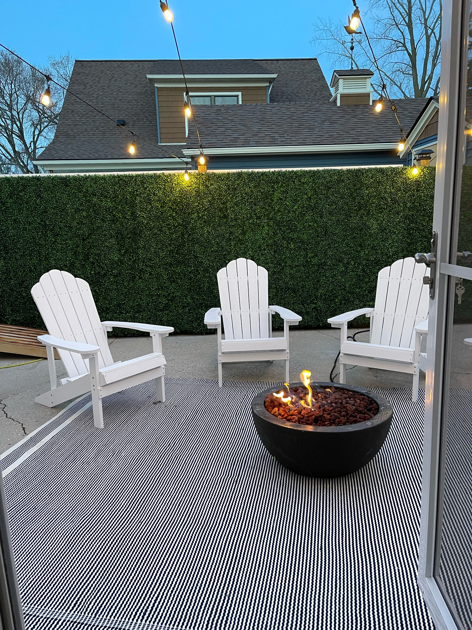 Outdoor patio at the cottage! 

Adirondack chairs, coastal, fire pit, string lights, McGee and co, rug, faux boxwood fence, coastal grandmother, light and airy

#LTKFind #LTKhome #LTKstyletip