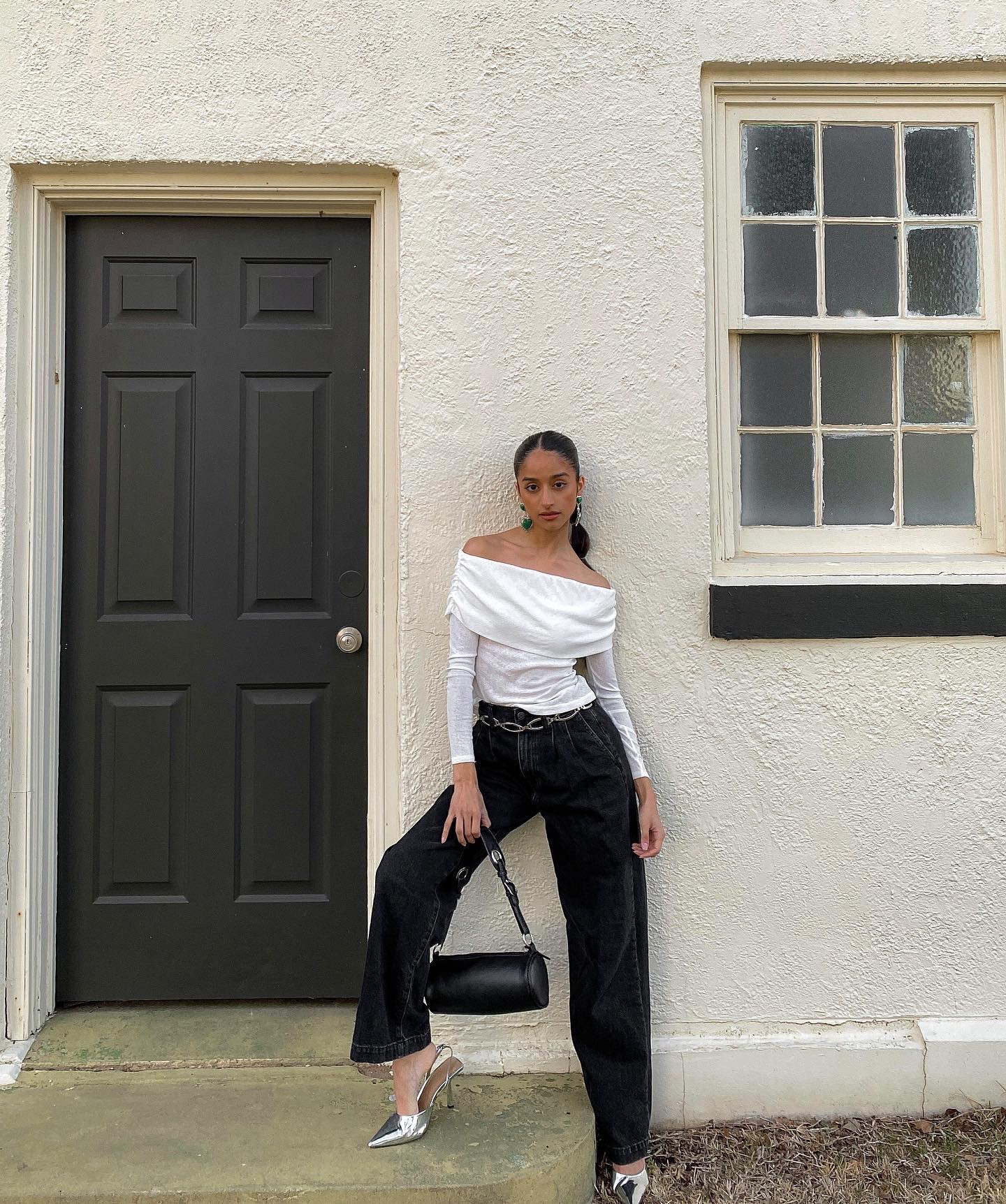 The perfect causal everyday outfit, but elevated! For this look, I wanted a to style a basic outfit that could easily be worn everyday, and then accessorize it with pieces that would make it look a lot more dressy than it actually is! I started with a basic fold over white top, and a pair of black jeans as the base (easy). I then used statement pieces to jazz it up: large heart drop earrings, silver pointed-toe kitten heels, a simple chain belt to add a pop to the center of the outfit, and a black buckle bag with silver hardware to tie in the silver and a add more dimension to the look! I focused on using silver to tie all the pieces together, and since the outfit was black and white, the color really helped make the outfit stand out. Minor detail, but I also decided to sleek my hair back in order to bring more attention to the earrings and allow my off the shoulder top to have its moment. 

Accessories in this outfit could easily be interchanged to your liking. Aka sneakers instead of heels, chunky hoops instead of drop earrings- but the styling principle stays the same: take a basic outfit and add statement accessories to elevate it. 

#LTKstyletip