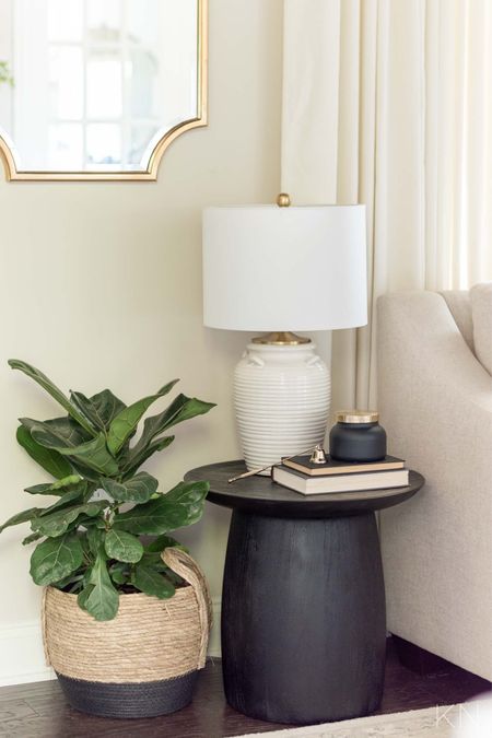 This white lamp is surprisingly affordable and fits perfectly on this small side table in our conversation room. home decor living room decor gold mirror candle snuffer accent table styling plant basket

#LTKhome #LTKstyletip #LTKunder50