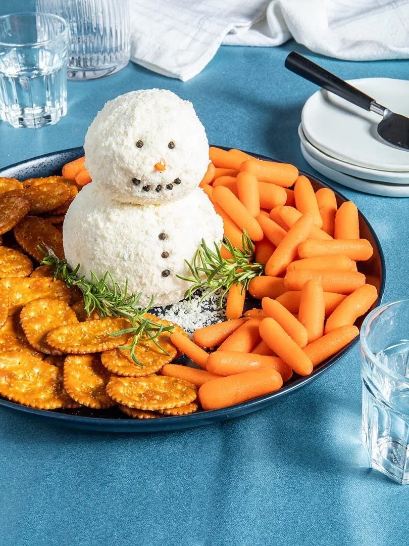 Whether or not the weather outside is frightful, this snowman cheese ball is so very delightful! Bring this adorable app to your holiday party or serve it at home for a festive winter-themed snack. The best part is that it’s super easy! All you have to do is mix up all the cheesy, herby goodness and turn it into the perfect snowperson!

Ingredients
* 16 oz cream cheese softened
* 2 cups Italian cheese blend (SEE NOTE at bottom)
* 1 tsp minced chives
* 1/2 tsp chopped fresh parsley
* 1/4 tsp chopped fresh rosemary
* 1/8 tsp garlic powder
* 2 cups grated Parmesan
* Black peppercorns for garnish
* Baby carrots for serving
* Crackers for serving

Instructions 
* In a medium bowl, combine the cream cheese, Italian cheese blend, chives, parsley, rosemary, and garlic powder. 
* Push the cheese into the center of the bowl and form into a ball. Cover the bowl with plastic wrap and refrigerate for at least one hour or up to overnight. 
* Separate the chilled mixture into two pieces, one bigger than the other. Use your hands to roll them into balls. (Pro tip: Use the plastic wrap while shaping the cheese for less mess and a smoother shape!) Place the Parmesan in a bowl. Working one at a time, roll the cheese balls in the Parmesan (or pat the cheese onto the cheese). 
* Stack the smaller ball on top of the bigger ball. Push the cloves into the cheese balls to make your snowman’s face and buttons. Cut one baby carrot into a small triangle and push into the snowman’s face as a nose. 
* Serve on a platter with crackers and carrots on the side. 
* NOTE: If a bag of Italian Style Shredded Cheese Blend is unavailable, here is a mix, ½ cup shredded mozzarella, ½ cup shredded parmesan, ¼ cup shredded asiago, ¼ cup shredded fontina, ¼ cup shredded provolone. 
https://ainttooproudtomeg.com/snowman-cheese-ball/

#LTKSeasonal #LTKHome #LTKHoliday