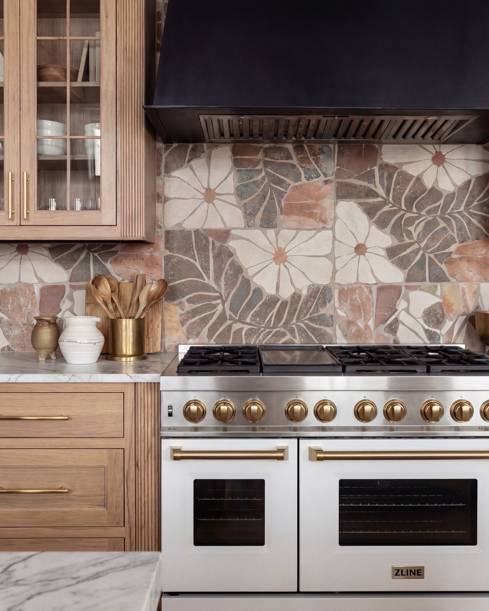 This kitchen is the definition of warm luxury done right. The natural oak cabinets, fluted island detailing, and marble counters create that soft, elevated palette everyone’s obsessed with right now. And can we talk about the pendants? Those sculptural white + brass beauties pull the whole space together.

The mixed-tone floral backsplash adds the perfect touch of personality without overwhelming the room, and the white range with brass hardware… she’s the star. Layered marble, muted runner, boucle bar stools, and gold accents make everything feel curated but still livable.

Shop the Look:
• Natural oak cabinetry (with fluted island detail)
• White + brass sculptural pendant lights
• White gas range with brass trim
• Warm floral tile backsplash
• Boucle + brass bar stools
• Marble countertops (soft veining)
• Brass kitchen hardware
• Ceramic vases + stone serveware
• Neutral vintage runner
• Gold tray + candle holders
• Oak beams (warm rustic contrast)

#LTKSaleAlert #LTKSpringSale

#LTKsale #LTKhome
