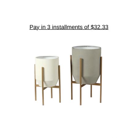 Showcase your indoor greenery in these two sleek metal cache pot planters in goldtone stands, lending a modern flair to your space. From Luxen Home.
Includes large gray white container, small white container, and two metal stands
For indoor use; Not waterproof; Add your own potted plants
Approximate measurements: Large 13"Diam x 24.75"H; Small 10.75"Diam x 20.2"H
Iron construction

#LTKGiftGuide #LTKsalealert #LTKhome