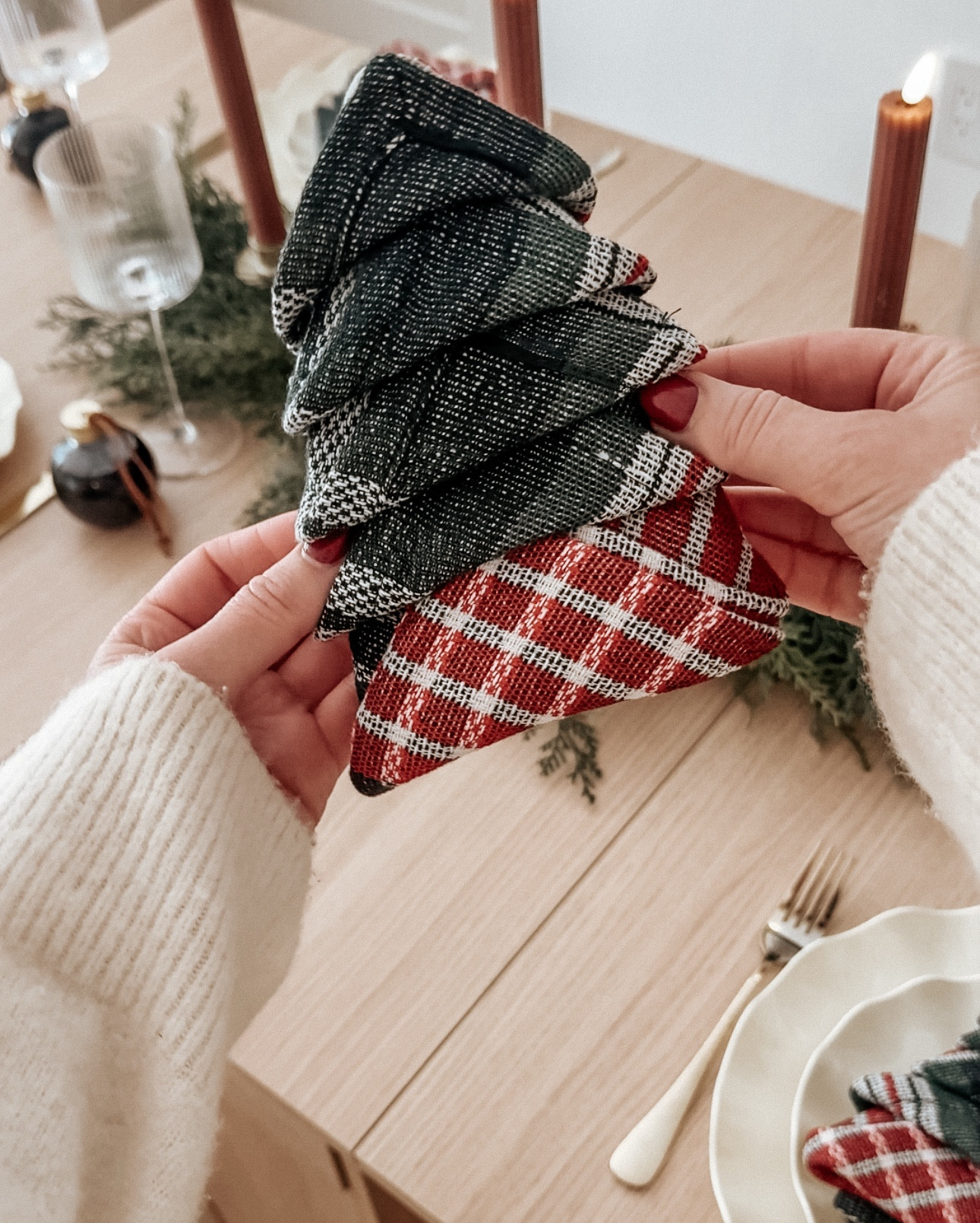 These napkins are giving classic Christmas with a hint of that Ralph-Lauren-holiday feel. Simple, festive, and the easiest way to make your table feel warm and cozy!

A classic, cozy touch for your holiday tablescape 🌲

How to:

	1.	Fold the napkin in half.
	2.	Fold it in half again to make a square.
	3.	Rotate it so the open corners face you.
	4.	Lift each layer up one by one, leaving a small gap between each fold.
	5.	Flip the whole napkin over, holding the folds in place.
	6.	Fold the left and right sides in to form a triangle.
	7.	Flip it back over and tuck each layer’s tip up underneath the one above it.
	8.	Adjust the layers so it looks like a little tree.

#holidaydecor #holidayparty #holidayseason #christmasdecor #tablescape 

#LTKHome #LTKStyleTip #LTKHoliday