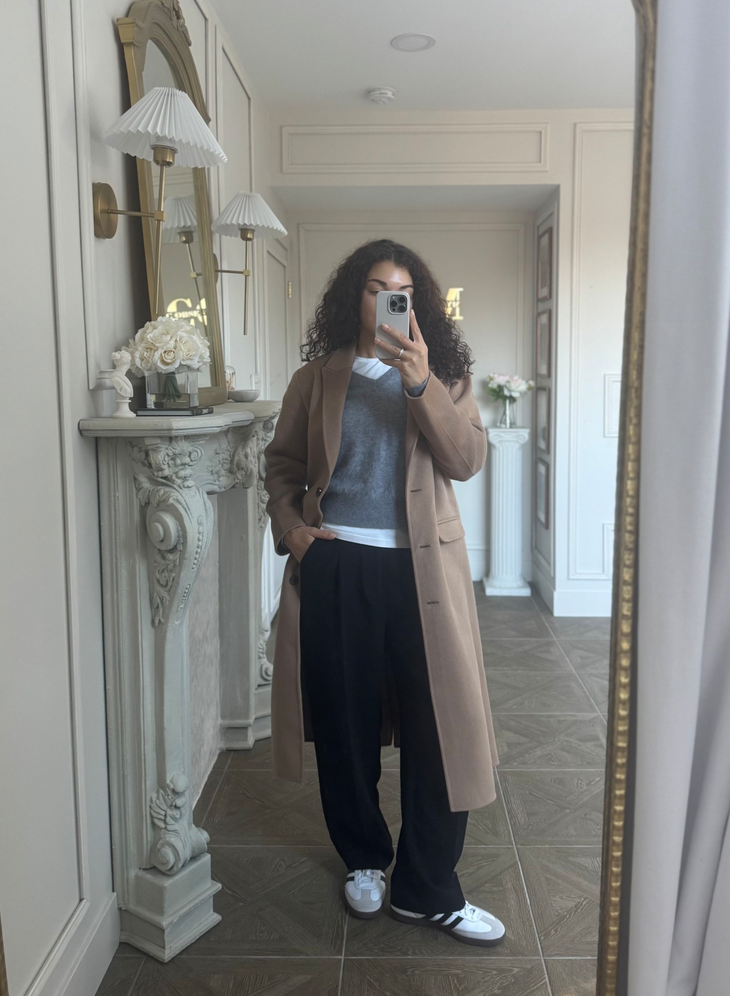 Casual chic outfit: white tee, v-neck sweater, black pants, sneakers, wool coat 

#LTKootd