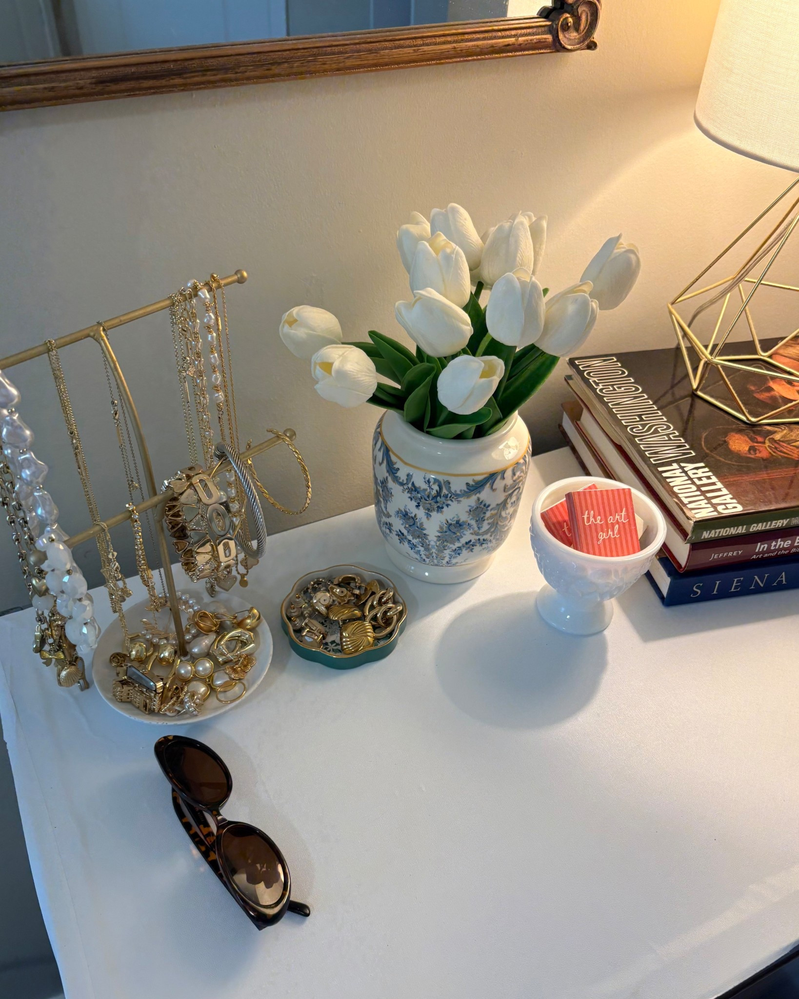 i love a little dressing table situation. especially when it's filled with all of my favorite things like gold jewelry, a vase with tulips, and my art coffee table books! 

 #LTKHome #LTKFindsUnder50