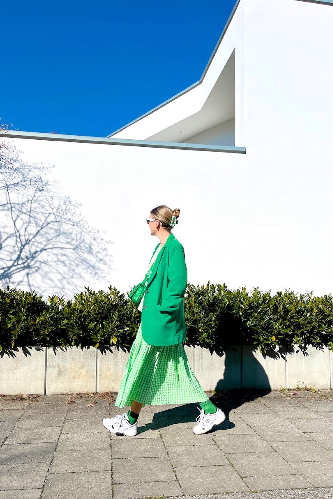 Gingham Dress. Fashion Blogger Girl by Style Blog Heartfelt Hunt. Girl with blond hair wearing a gingham dress, oversized green blazer, check board print hair claw clip, green braided JW Pei bag, oversized sweatshirt, green socks and New Balance sneakers. #springlook #ginghamdress #springdress #colorfuloutfit #colorfulstyle #colorfulfashion #colorfullooks #fashionfun #cutespringoutfit #springfashion2023 #springlookbook #fitcheck #dailylooks #dailylookbook #contentcreator #microinfluencer #discoverunder20k