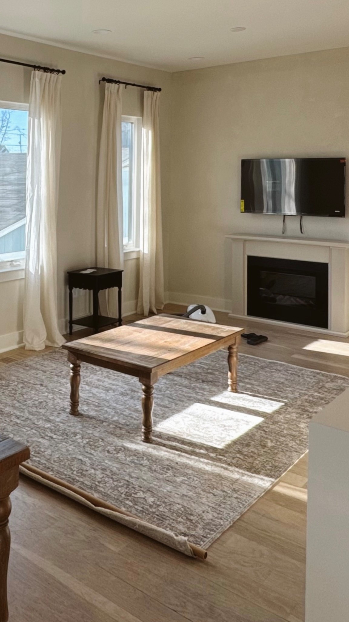 Neutral living room. Amber interiors rug. Wood coffee table. Electric fireplace. Linen light filtering pinch pleat curtains

#LTKHome