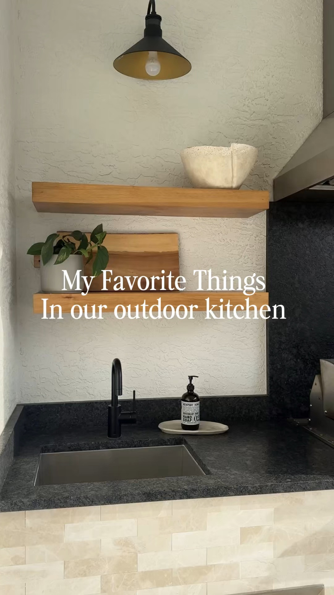Sharing my favorite details about our outdoor kitchen - linking the exact products we used! 

I used four of the floating shelves sold in a two pack and use the color natural - I’m very impressed with the quality of these prebuilt shelves and came with all the hardware to install. 

I know the fridge seems like a splurge, but living in Florida. We needed a good quality fridge that would stand the time of our Florida Summers. So far it stood the test of time for one year! 

Since we don’t use the lights every night, the charge on the magic bulbs is lasting forever. They are definitely not a nuisance and I love how they have so many different lighting color options.

The small little details of soap and a hand towel outside just makes the space feel lived in and ready to go at any moment. I concentrated on mixing up the materials outside, so I brought in a cement tray for the amber glass soap dish. It pops really nicely on our steel gray leathered granite.

Save this post for your outdoor kitchen in inspiration! 
