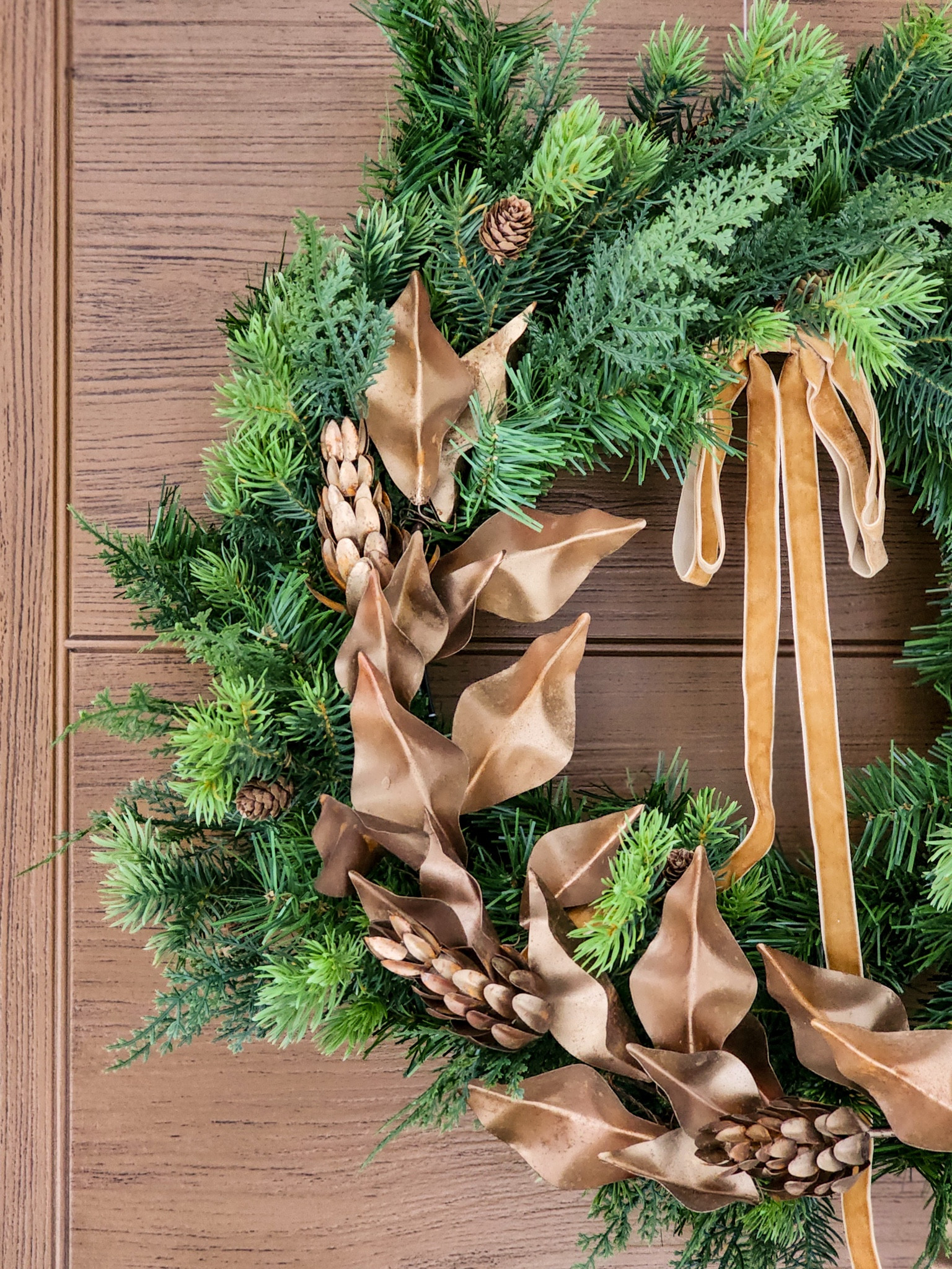 I layered the brass metal wreath I used for fall over a faux pine wreath to create the perfect winter door decor, topped with a velvet ribbon bow.

#LTKSeasonal #LTKHome