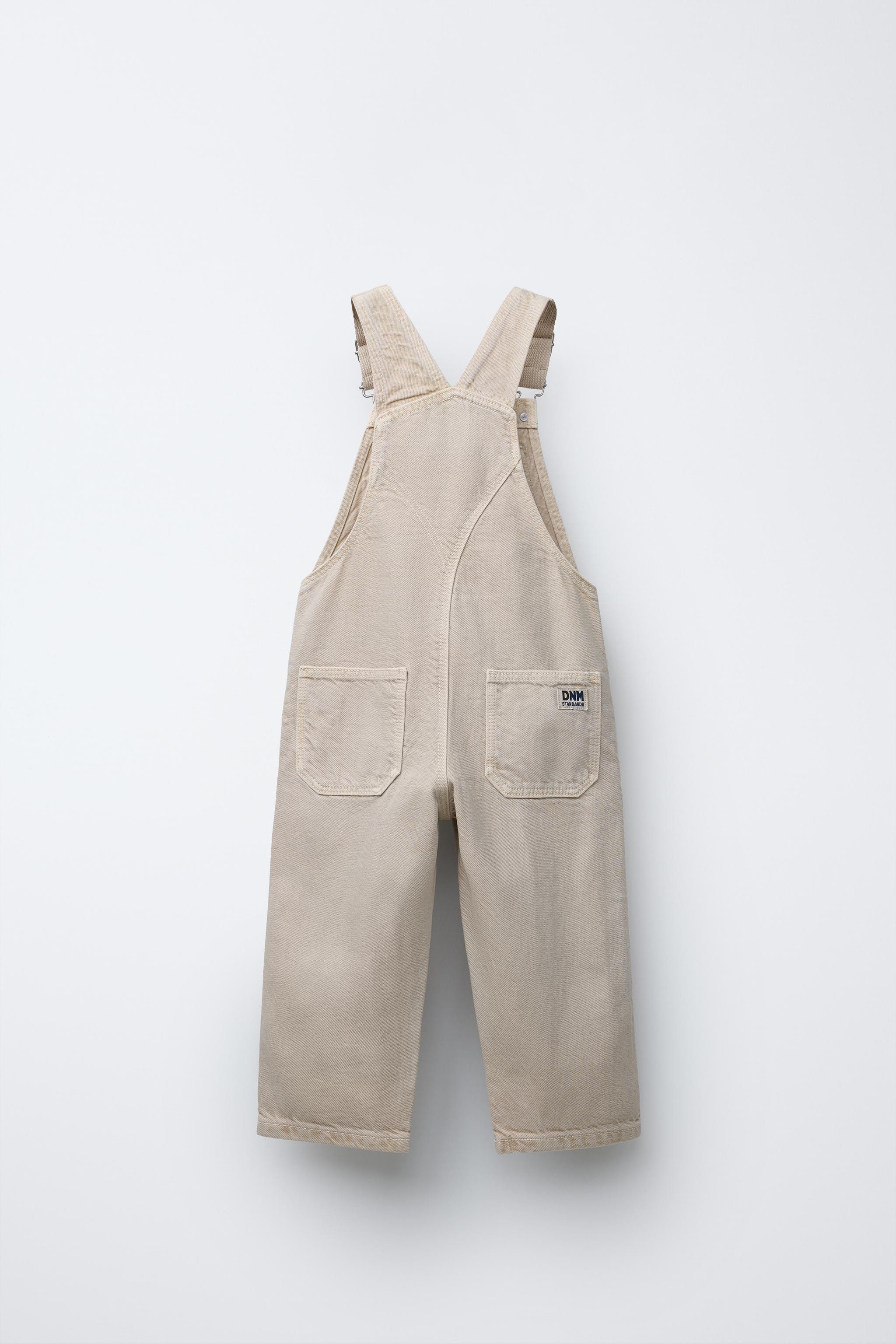 Long overalls with a straight neck and adjustable buckle suspenders. Side snap buttons. Front poc... | Zara US