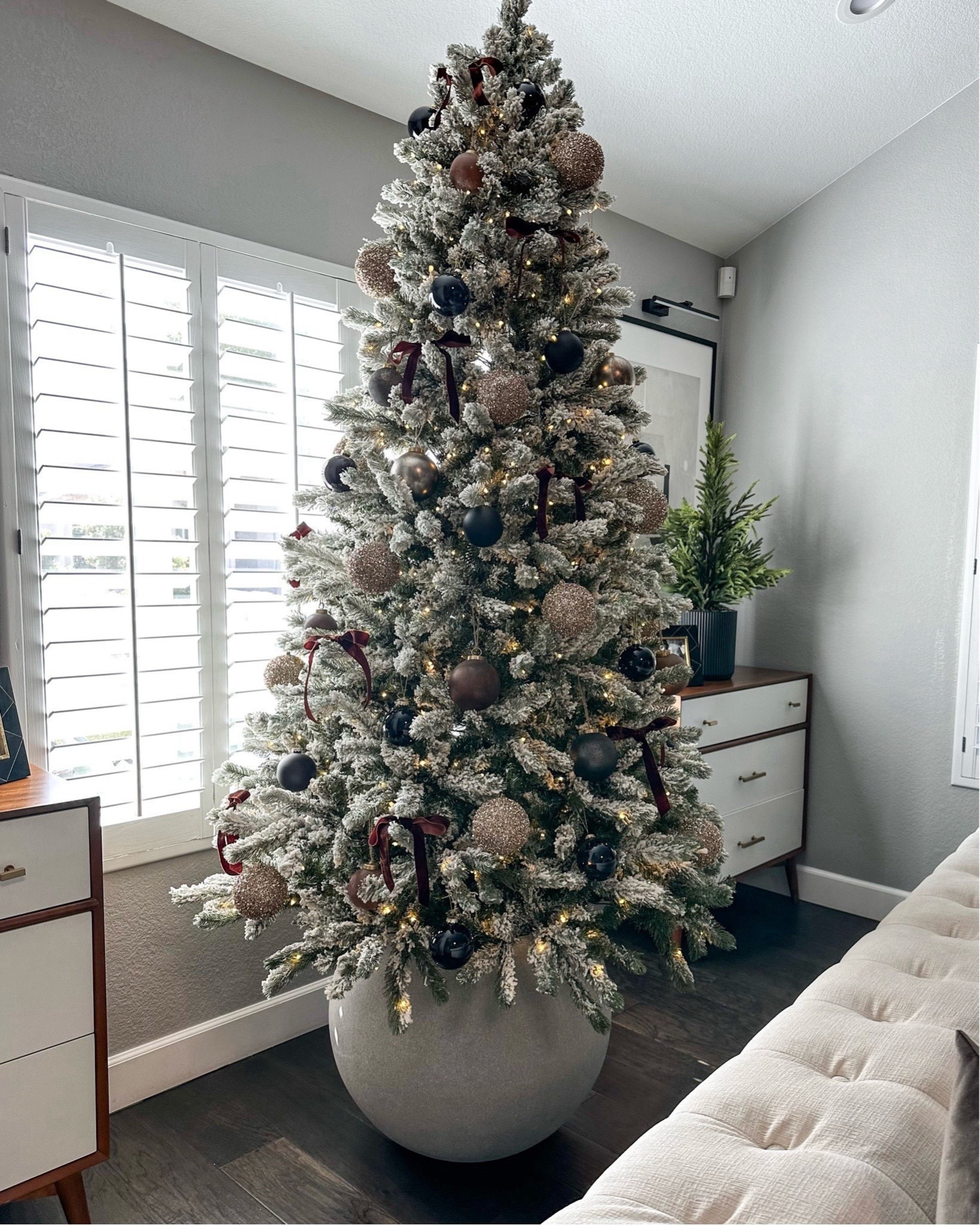 Save $300 on my Christmas tree Flocked tree with round planter base 
Browns, blacks and rust ornaments I’m loving again this year…the crate and barrel ones are my absolute favorite!
I always have 7 trees out but I will change them up, switch up which trees get what ornaments, or rotate the trees out each year depending on my mood..I’ve never had a tree in this spot and love that the planter raises it higher than the couches to see it better, and it’s different and modern 
Modern organic, neutral Christmas decor 
#ltkseasonal


#LTKHome #LTKSaleAlert #LTKHoliday