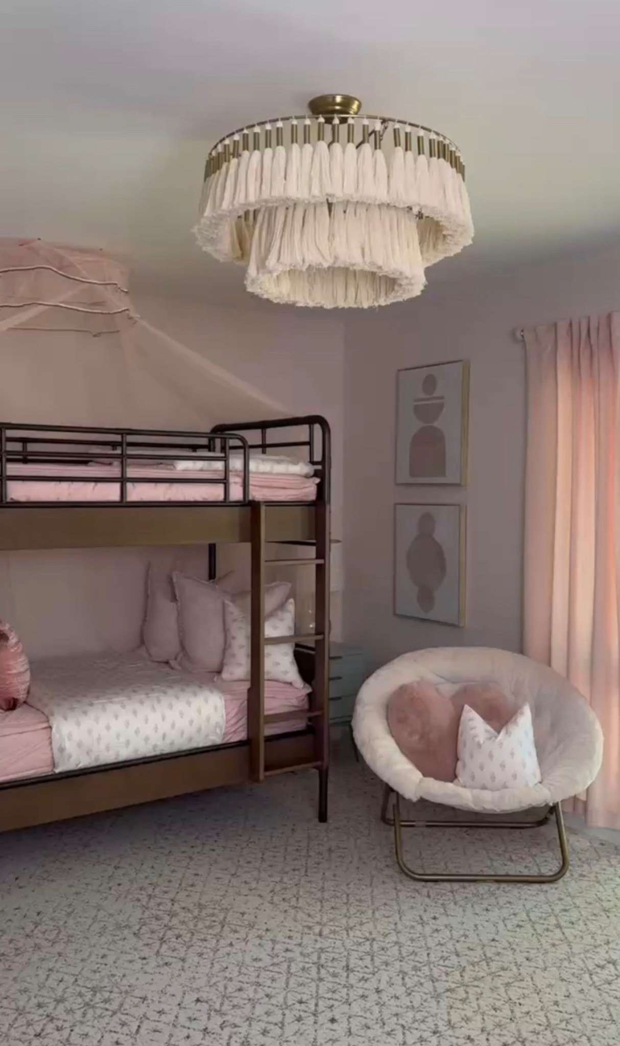 Soft, sweet, and perfectly styled 🤍 This girls bedroom blends function and charm with a metal bunk bed, canopy bunk, and cozy blush bedding layered with decorative throw pillows. The round accent chair with a gold frame creates the perfect reading nook, while the fringe chandelier / fabric ceiling light adds a whimsical touch. Finished with neutral area rug, pink curtains, and minimal wall art, this space is ideal for a shared kids room or modern kids bedroom with a soft, feminine feel.

#eanesinteriors #girlsbedroom #kidsbedroomdecor #bunkbed #metalbunkbed #canopybed #kidsbedding #pinkbedding #accentchair #roundchair #nurserydecor #kidsroominspo #bedroomlighting #fringechandelier #ltkhome #ltkdecor

#LTKHome #LTKSeasonal #LTKOver40