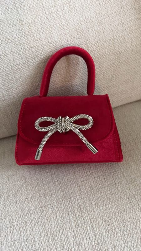 Mini bag in a pop of red! Crystal bow. Can hold credit cards, lipstick, keys. Lots of great colors available! Love it for the holidays! @meliebianco 

#LTKHoliday #LTKVideo #LTKGiftGuide