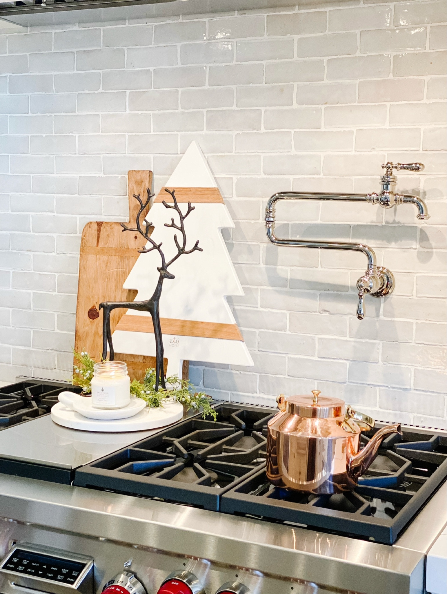 Kitchen holiday vignette
Christmas tree cheese board
Metal reindeer 
Copper tea kettle
Pot filler
